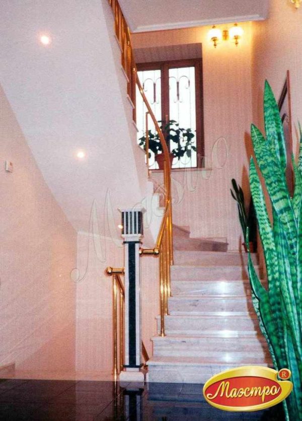 Изогнутая монолитная лестница с латунным ограждением